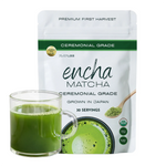 A white stand-up pouch of Encha Matcha ceremonial grade matcha powder, shown with a clear glass mug filled with green matcha tea in front of it on a white background. _60g (2.12oz) 30 cups