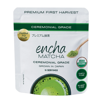 A stand-up pouch of Encha Matcha ceremonial grade matcha tea on a plain white background. The packaging is white with green accents, featuring a green matcha powder scoop illustration, a gold 'Farm to Cup' seal, and circular badges indicating USDA Organic, dairy free, and sugar free. _30g (1.06oz) 15 cups
