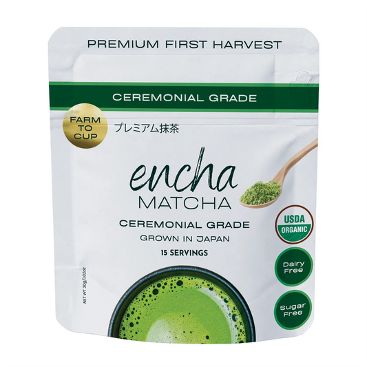 A stand-up pouch of Encha Matcha ceremonial grade matcha tea on a plain white background. The packaging is white with green accents, featuring a green matcha powder scoop illustration, a gold 'Farm to Cup' seal, and circular badges indicating USDA Organic, dairy free, and sugar free. _30g (1.06oz) 15 cups