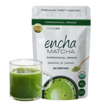 A pouch of Encha Matcha ceremonial grade matcha tea powder next to a clear glass mug filled with green matcha tea, on a white background. _500g (1.1lb) 250 cups