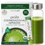A box of Encha Ceremonial Grade organic matcha tea alongside a clear glass bottle filled with brewed green matcha and a single stick pack, on a white background. _Single serve sticks 30 pack