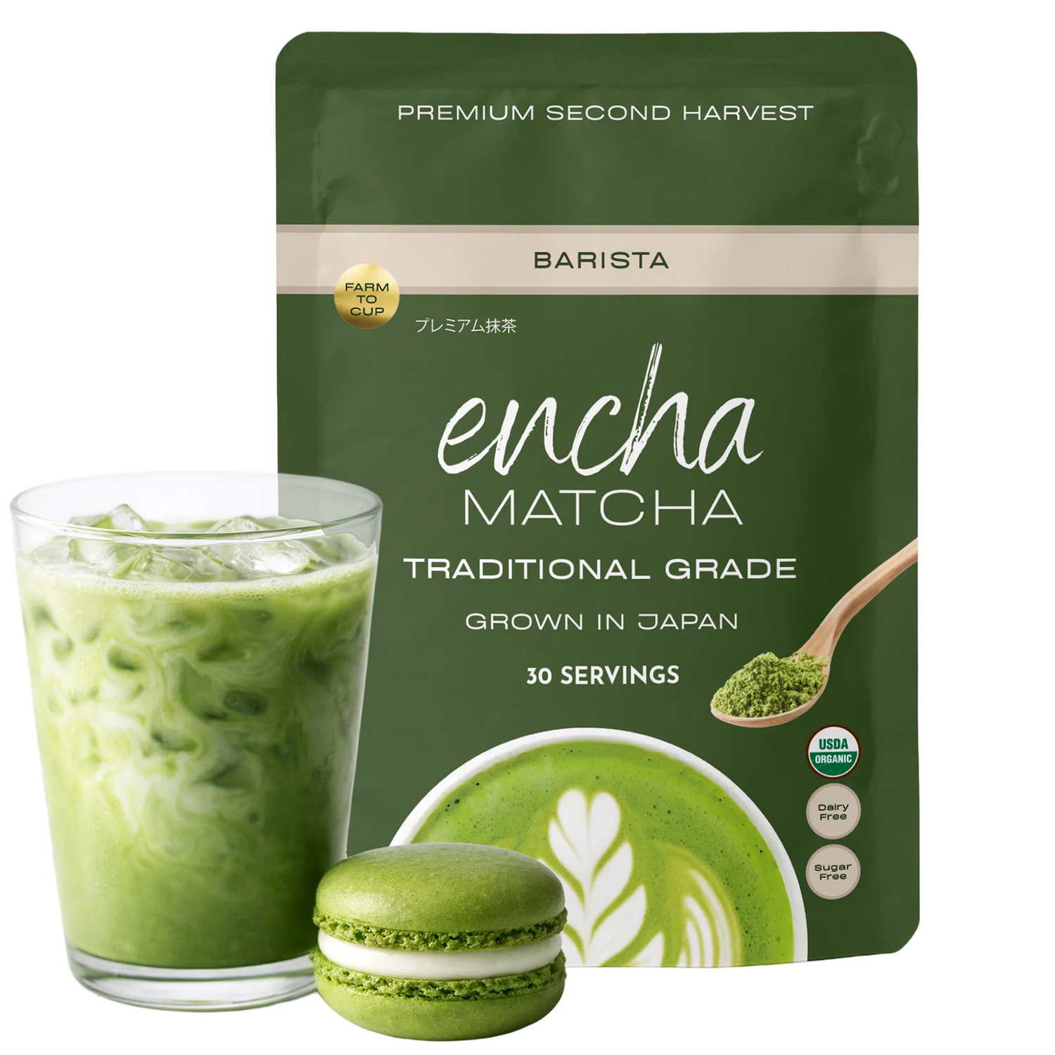 A pouch of Encha Matcha Traditional Grade matcha powder stands behind a glass of green iced matcha latte and a green matcha macaron, on a clean white background. _60g (2.12 oz) 30 cups