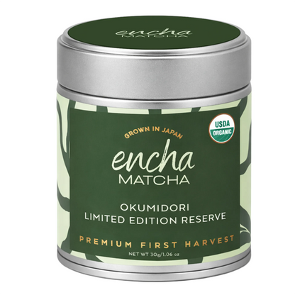 A cylindrical metal tin of Encha Matcha Okumidori Limited Edition Reserve, featuring a dark green label with white and gold text, a silver lid, and a USDA Organic seal on a white background.