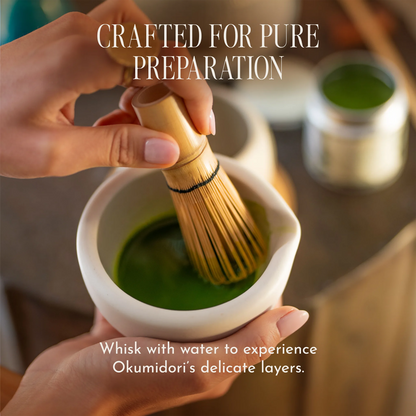 A close-up of hands whisking green matcha powder in a white ceramic bowl using a bamboo chashaku, with text reading 'CRAFTED FOR PURE PREPARATION' and 'Whisk with water to experience Okumidori's delicate layers.'.