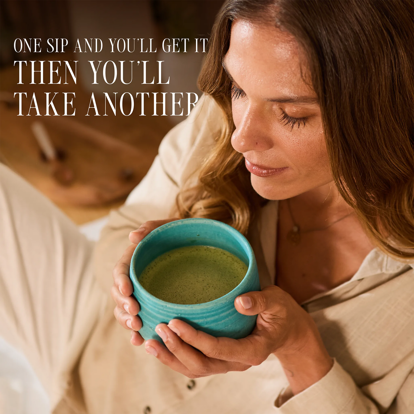 A woman in a beige shirt holds a turquoise ceramic mug filled with a green beverage, with the text 'ONE SIP AND YOU'LL GET IT THEN YOU'LL TAKE ANOTHER' overlaid on the top left.